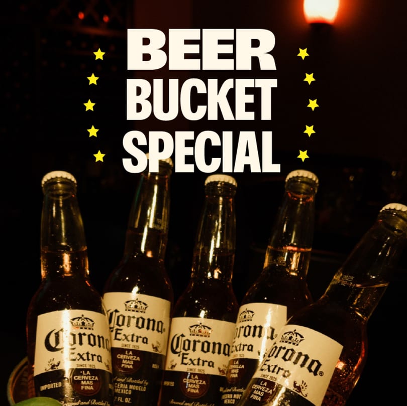 Five Corona Extra beer bottles in a bucket, with "BEER BUCKET SPECIAL" text and stars.